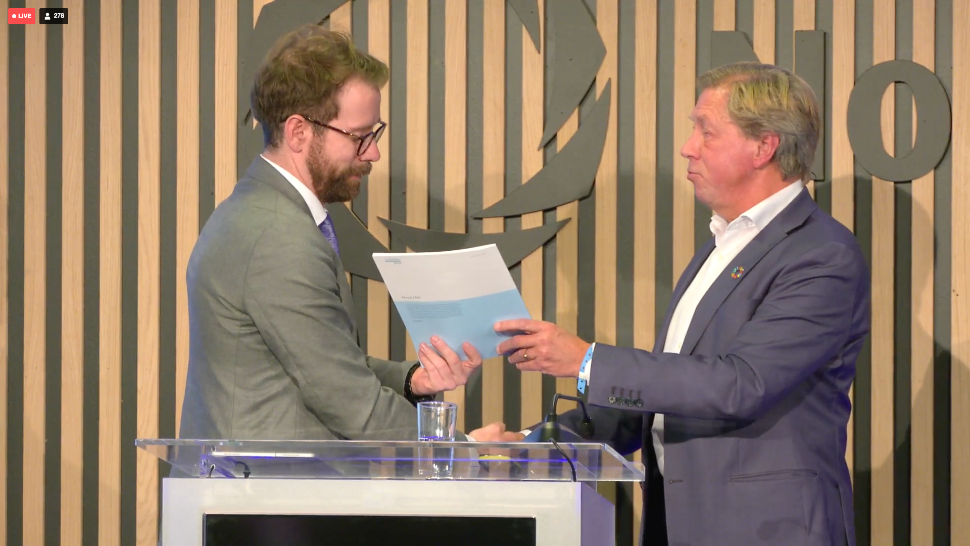 Nils Klippenberg overleverer rapporten til Amund Vik, statssekretær i OED. Foto: Screenshot / DNV